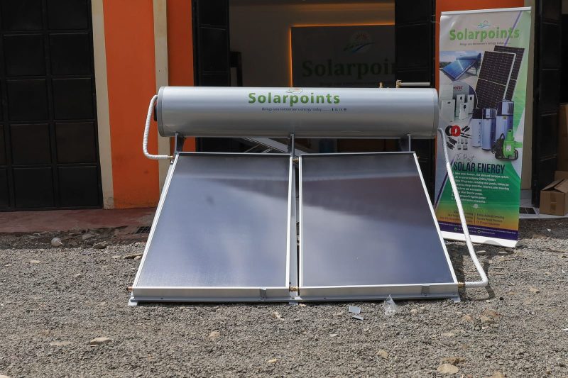 Twin panel flat plate solar water heater with grey G-steel tank outside a showroom
