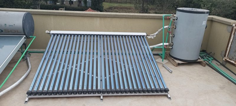 Split solar water heater with vacuum tube collector and separate storage tank on a rooftop